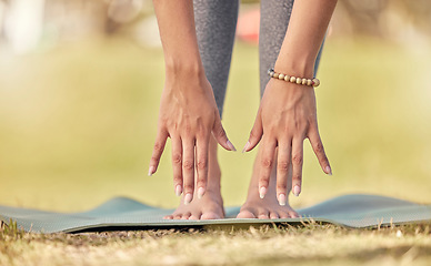 Image showing Hands, yoga and stretching with a sports woman practicing meditation on a field outdoor in summer. Fitness, peace and wellness with a female athlete getting ready for workout, exercise or meditation