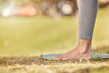 Image showing Woman feet, mat and yoga on grass, park and exercise, meditation and spiritual wellness in nature for zen. Female, pilates or cardio person with workout training for peace, calm and healthy lifestyle