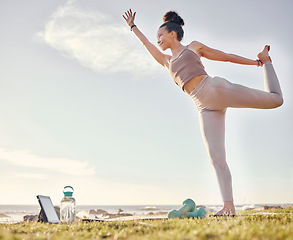 Image showing Yoga, tablet and nature with a woman athlete by the ocean for inner peace, wellness or zen exercise. Fitness, health and technology with a female yogi enjoying the view while stretching for training