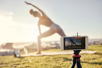 Image showing Fitness, woman and yoga live stream with phone stand for social media, vlogger or exercise tutorial in nature. Female in spiritual, zen and wellness training recording sports workout on smartphone