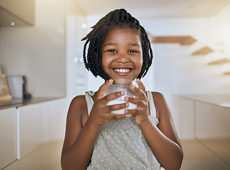 Image showing Child, happy and healthy milk drink for energy vitamins or health wellness at home. Black girl portrait, glass and drinking dairy breakfast or calcium nutrition for kids teeth health care in kitchen