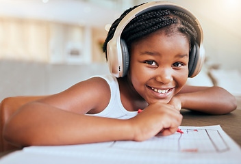 Image showing Online education, headphones and african girl in portrait writing, drawing and learning at home in virtual class happy with her language audio assessment. Black student child in elearning video call