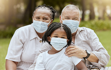 Image showing Family portrait, covid and face mask outdoor at nature park with child and grandparents together on picnic for love, care and summer bonding. Man, woman and girl with covid 19 safety compliance