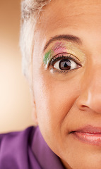 Image showing Creative, woman and eye with colorful, makeup and natural beauty being trendy, casual and cool against brown studio background. Senior female, cosmetics and being elegant, artistic and skincare.