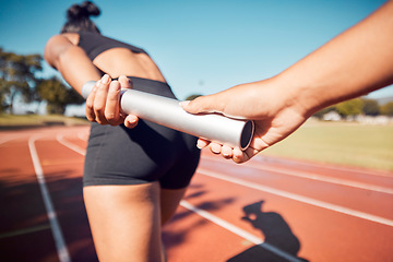 Image showing Fitness, woman and hands on baton for relay sports, training or running competition on the stadium track. Active female in athletics sport holding bar for competitive race, sprint or team marathon