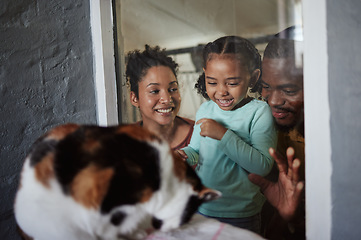 Image showing Family, animal shelter and child excited about a cat while doing volunteer or charity work with a smile and happiness of mother, girl and father. Man, woman and kid at vet window for adoption of pet