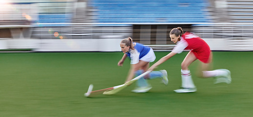 Image showing Hockey, action and running women in a game, competition or sports event for goal with speed, energy and motivation challenge. Stadium, turf field and athlete people run together with stick and a ball
