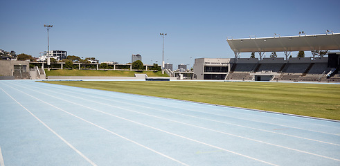 Image showing Race track, athletic and empty outdoor sports stadium for marathon, competition or challenge. Sport, no people and field at outside arena for training, exercise or workout for professional athletes.