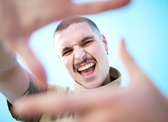 Image showing Face hands frame, smile and man portrait feeling happy about beauty, fashion and skincare. Smile, comedy and silly gen z model with a aesthetic hand sign feeling happiness, creativity and funny