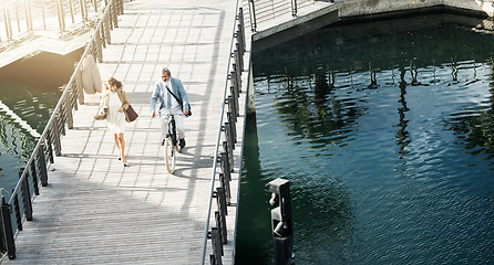 Image showing Travel, cycling and bike with business people on bridge in the morning for transportation, commute and carbon footprint. Eco friendly, health and river with employee and cross for journey on lake