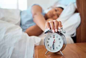 Image showing Alarm clock, bedroom and woman stop time to wake up from early morning sleeping at home, house and apartment. Tired female snooze watch timer, noise alert and sound for waking up to start sunrise day