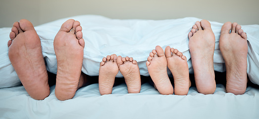 Image showing Family, feet and bed in morning for relax, calm and sleeping in bedroom together. Mother, father and young child resting in morning, dreaming and weekend nap or relaxing holiday in family home