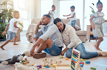 Image showing Tired, family and children running in living room with toys and playing for energy, noise and active. Burnout, headache and stress with mom and dad with fatigue and kids for crazy, adhd and youth