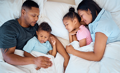 Image showing Family, sleeping and in bed together, love and care with parents and children at family home. Mother, father and kids rest, relax and sleep comfortable in bedroom with cuddle and bonding.