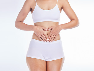 Image showing Health, heart and hands on woman stomach for training, nutrition and balance gut wellness. Menstruation, digestion and fitness with girl body for diet, probiotics or hair removal in white background