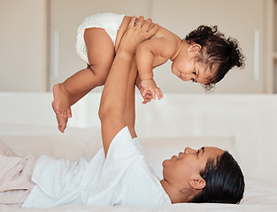 Image showing Love, mother and baby in the air in bedroom, being playful and bonding together in home. Mama, toddler and child playing on bed, being loving and connect for quality time, happiness and have fun.