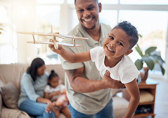 Image showing Dad, boy and toy plane in living room for game, fun or bonding while happy together. Father, son and play airplane toys with smile at house with love, happiness or family home lounge in Orlando