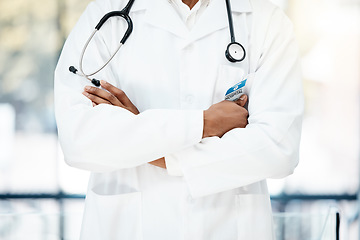 Image showing Closeup, healthcare and doctor with arms crossed, stethoscope and confidence in hospital. Medical professional, uniform and consultant healthy, in clinic and medicine for wellness and surgery.