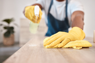 Image showing Black man, hands and spray bottle and cleaning cloth on house table, home desk or office building counter top. Zoom, gloves and fabric bacteria product for hygiene maintenance and healthcare wellness