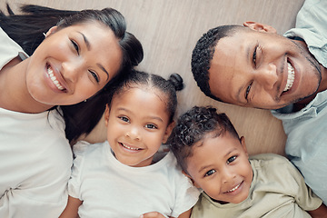 Image showing Top view, floor and portrait of black family in home with happiness, love and smile on faces. Holiday, children and overhead of mom and dad with kids bonding, have fun and spend quality time together