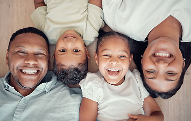 Image showing Top view, parents or children bonding on floor in house bedroom or home living room in fun, playful or happy family portrait. Smile, mother or father and kids, girl or boy in trust, security and love