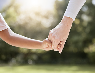 Image showing Park, family and parent holding hands with child enjoying nature, summer holiday and weekend together. Bonding, support and person holding hand of young kid with affection, love and care in nature