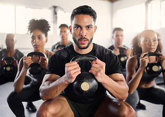 Image showing Squat, kettlebell and fitness coach in a gym exercise, power and workout wellness class. Portrait of a sport personal trainer with focus on training people for health goals and sports cardio