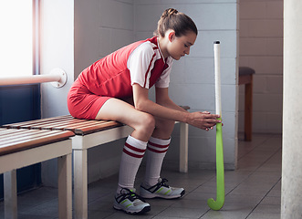 Image showing Hockey, sports and defeat with a woman athlete on a bench in the locker room after a competitive game loss. Fitness, exercise and sad with a female hockey player in the changing room of a sport club