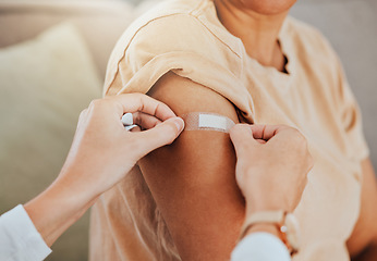 Image showing Healthcare, doctor and patient with covid vaccine injection plaster on arm for immune medicine, bandaid and medical treatment to prevent disease. Clinic vaccination, safe and healthy woman after shot