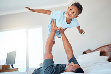 Image showing Father lifting kid in air in the bedroom having fun, playing and enjoying morning together. Bonding, love and dad holding young child in bed to pretend to fly for quality time and relax with family