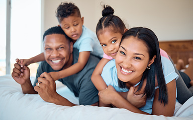 Image showing Happy, smile and portrait of a family in a bedroom to relax, play and bond together at their home. Happiness, love and parents relaxing with their children while being playful on a bed at their house