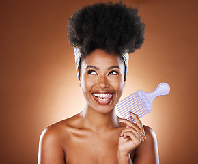 Image showing Hair care, comb and black woman with smile, natural beauty or stylish for wellness on brown studio background. Afro, African American female or girl with headscarf, body care or skincare or face glow