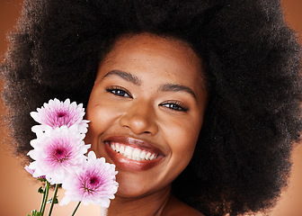 Image showing Black woman, face or afro hair with daisy flowers on studio background for gentle skincare, vibrant glow or organic dermatology. Zoom, portrait or happy smile beauty model with natural hair and plant