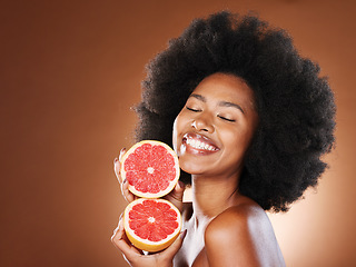 Image showing Black woman, afro hair or grapefruit for face skincare, healthcare wellness glow or vitamin c dermatology routine. Smile, happy or beauty model with natural hair, citrus food or vegan facial product