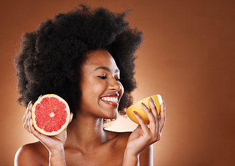 Image showing Grapefruit, black woman and vitamin c beauty, skincare and wellness, healthy body or aesthetics, natural cosmetics and afro on studio background. Happy young african model eating citrus for nutrition