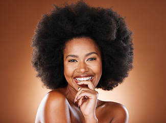 Image showing Happy, black woman and hair care with smile, skincare and with afro, glow and beauty in browns studio background. Portrait, cosmetic or skin health of a person with happiness, content or smiling joy