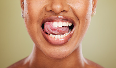 Image showing Tongue, teeth and african woman in closeup with lick, smile or happy for dental wellness in studio. Model, mouth or perfect teeth whitening for health, medical or beauty by background in healthcare