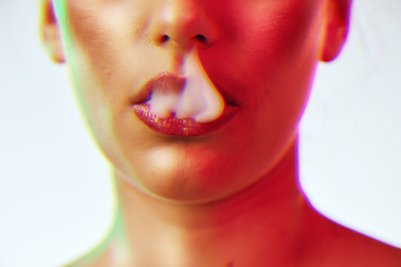 Image showing Beauty, cosmetics and woman lips with smoke with neon red lighting in studio on white background. Creative, artistic and half face of girl with makeup, lipstick and cyber aesthetic for smoking vape