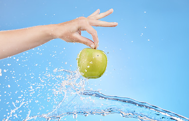 Image showing Apple, water splash and hands of health woman with organic product for healthy lifestyle, antioxidants or fruit detox. Clean natural diet, nutritionist and girl with weight loss food for body care