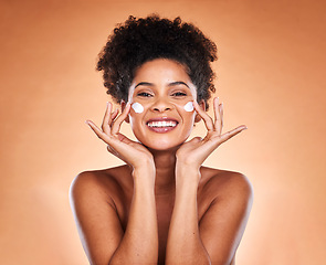 Image showing Sunscreen, black woman with skincare product on face and beauty in studio with orange background in Atlanta. Healthy smile for portrait, collagen cream for facial glow or cosmetic lotion for acne