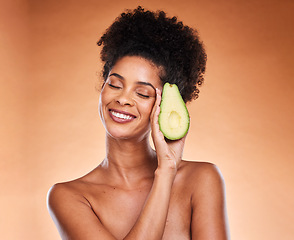 Image showing Skincare, wellness and black woman with avocado in studio on brown background for body care. Beauty, spa and female with vegetable for organic, natural and healthy beauty products and cosmetics