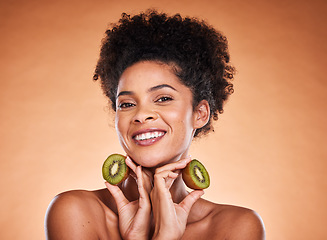 Image showing Kiwi fruit, beauty and black woman healthcare or vitamin c nutrition for skincare health. Portrait of African girl model, diet wellness or healthy cosmetics and facial care in brown background studio