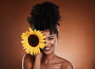 Image showing Beauty, skincare and portrait of model with sunflower for health, wellness or body care antioxidants. Facial cosmetics, natural makeup and face of black woman with vitamin e product for diy self care