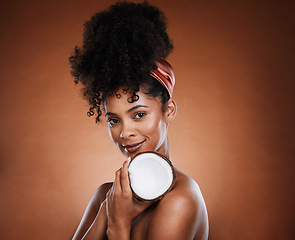 Image showing Woman, coconut fruit and body skincare glow on studio background for organic hydration, vegan moisture or holistic dermatology. Portrait, smile and happy african beauty model with coco butter product