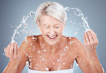 Image showing Mature woman, water splash or washing face in skincare grooming routine, morning hygiene maintenance or healthcare wellness. Smile, happy or elderly beauty model in facial cleaning and wet water drop