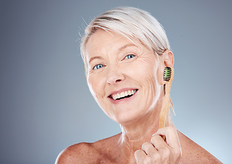 Image showing Toothbrush, smile and portrait of a senior woman with a healthy dental routine in a studio. Wellness, cosmetics and happy elderly model with oral care, hygiene and health isolated by gray background.