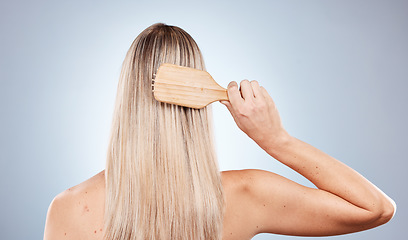 Image showing Hair care, beauty brush and back of woman in studio isolated on gray background. Hair style, grooming and female model brushing hair for healthy morning routine, wellness and cosmetics hair treatment