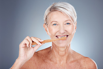 Image showing Mature woman, toothbrush and portrait for health, wellness and oral care on a grey studio background. Brushing teeth, clean and senior female cleaning her mouth for oral care or dental hygiene
