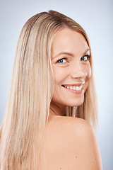 Image showing Hair care, smile and portrait of a woman in studio clean, beautiful and long blond hair. Beauty, cosmetic and happy model with keratin, brazilian or salon treatment for hair style by gray background.