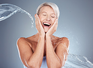 Image showing Mature woman, water and splash with shower for clean aesthetic health on a grey background. Beauty, bath and hygiene with a woman washing for bodycare, skincare and wellness for hydration